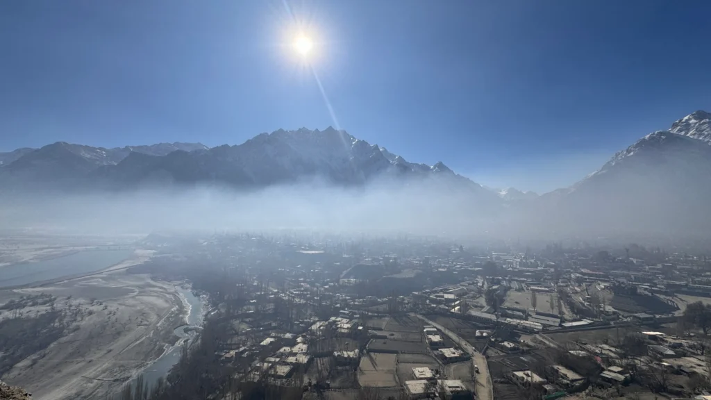 Skardu valley morning mist with Karakoram mountain peaks and terraced settlements before Braldu Valley trek