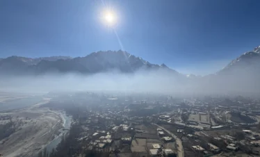 Skardu valley morning mist with Karakoram mountain peaks and terraced settlements before Braldu Valley trek